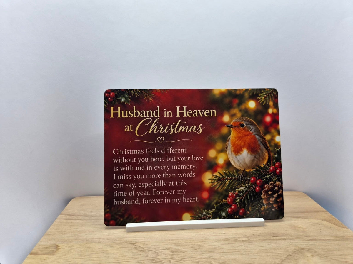 Husband in Heaven at Christmas memorial metal sign with a robin, holly and glowing festive lights, displayed in a white stand