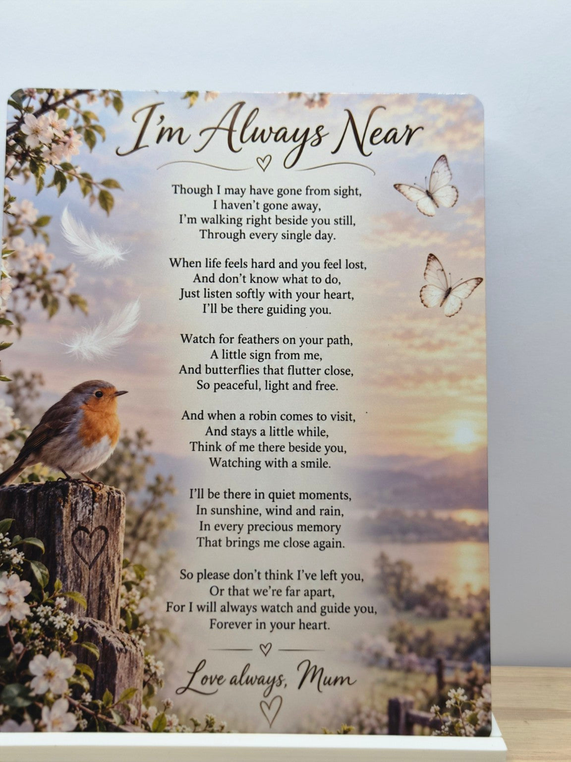 I'm Always Near Mum memorial metal sign with a robin, flowers and a remembrance poem over a soft landscape, displayed in a white stand