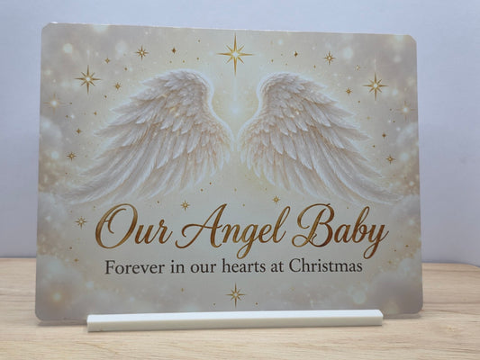 Our Angel Baby metal sign with white angel wings, gold-coloured stars and Forever in our hearts at Christmas wording