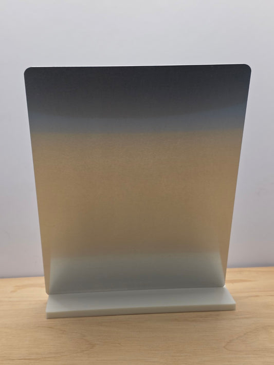 Rear view of a portrait metal sign displayed in its white freestanding stand