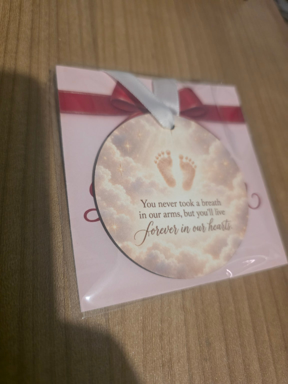 Memorial keepsake round hanging decoration example with baby footprints and heartfelt words