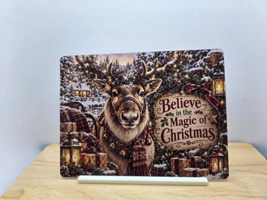 Believe in the Magic of Christmas reindeer metal sign with presents and lanterns on its white stand