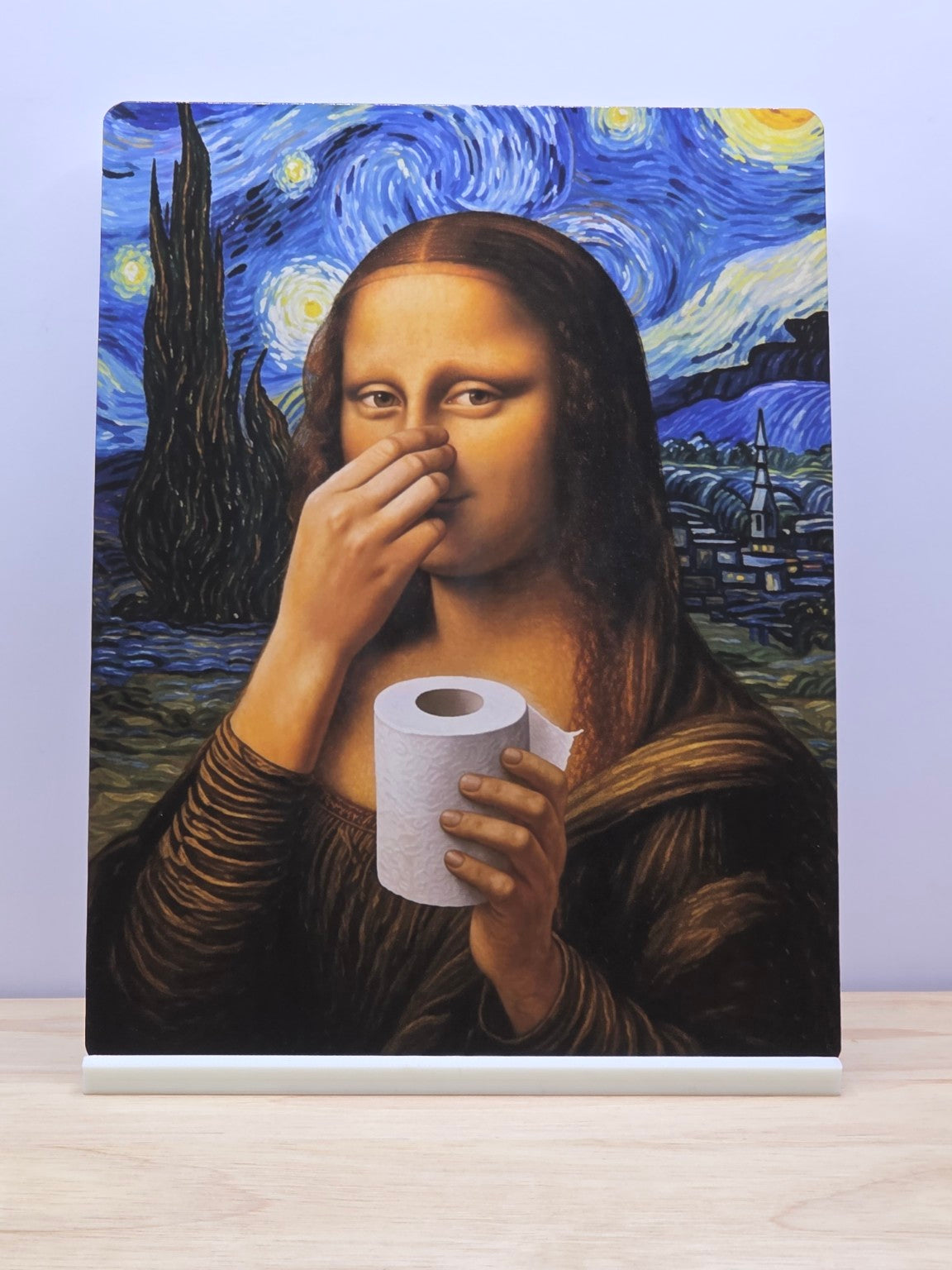 Mona Lisa bathroom parody metal sign holding her nose and a toilet roll against a swirling blue night sky, displayed in a white stand