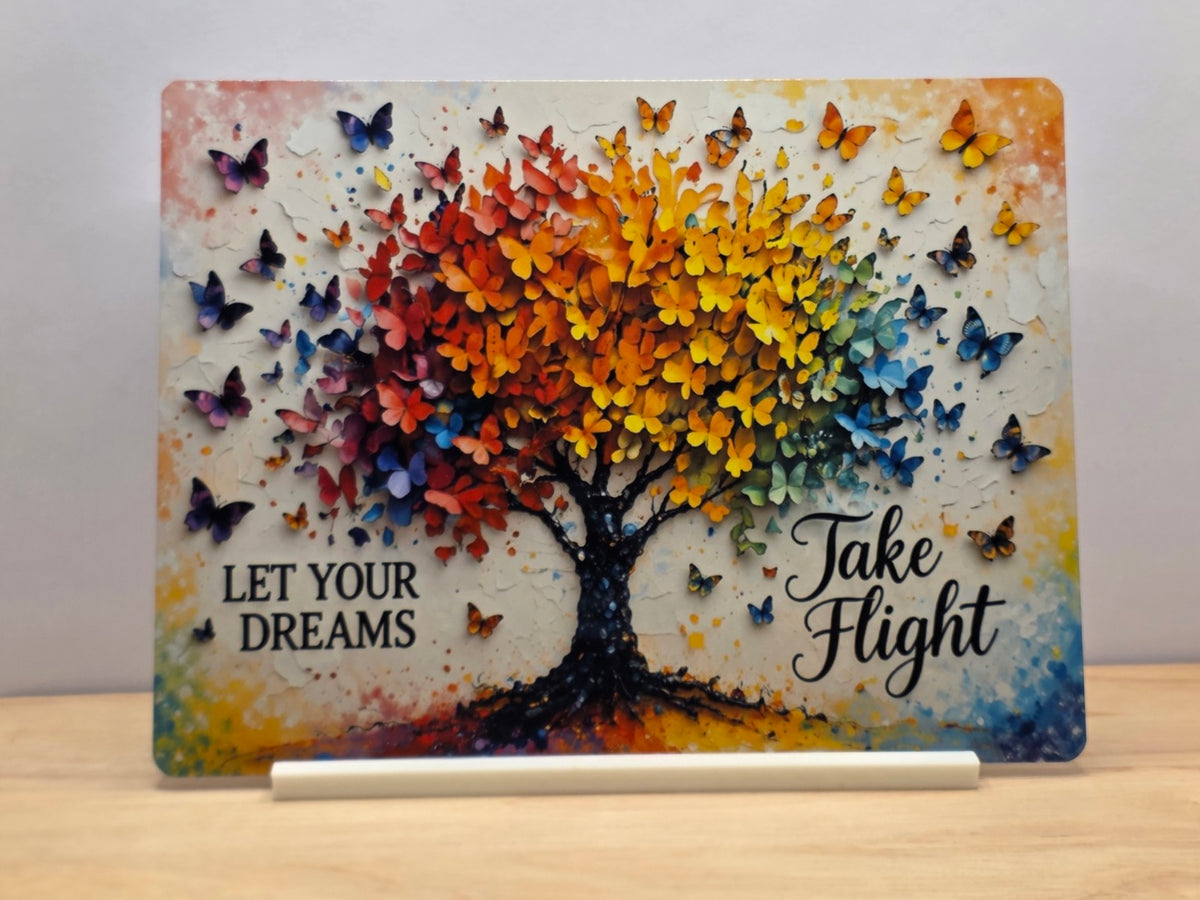 Let Your Dreams Take Flight metal sign with a rainbow butterfly tree displayed on a white stand