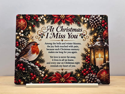 At Christmas I Miss You memorial metal sign with a robin, lantern, poinsettias and remembrance poem, displayed in a white stand