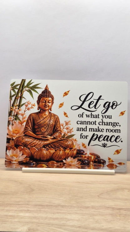 Golden-toned seated Buddha metal sign with lotus flowers and the words Let go of what you cannot change, and make room for peace