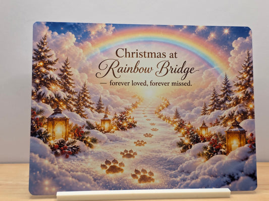 Christmas at Rainbow Bridge pet memorial metal sign with a rainbow, snowy paw prints and lanterns