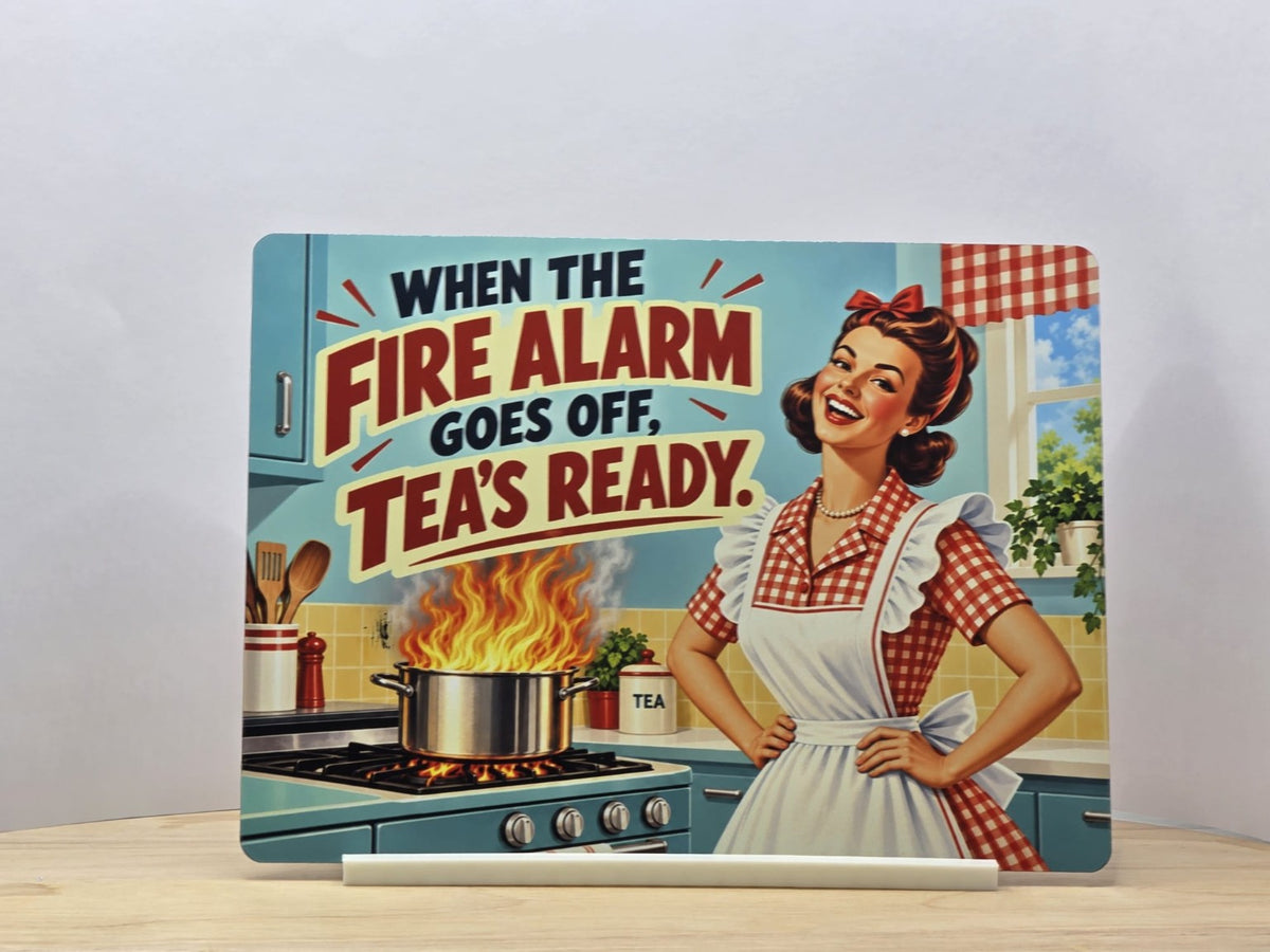 Retro funny kitchen metal sign reading When the fire alarm goes off tea's ready, with a woman and flaming saucepan