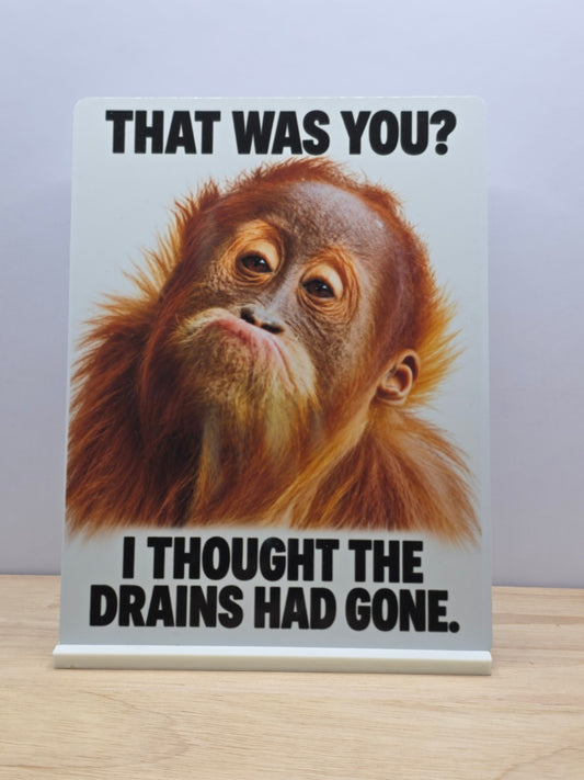 Portrait bathroom metal sign showing a puzzled orangutan and That was you I thought the drains had gone wording