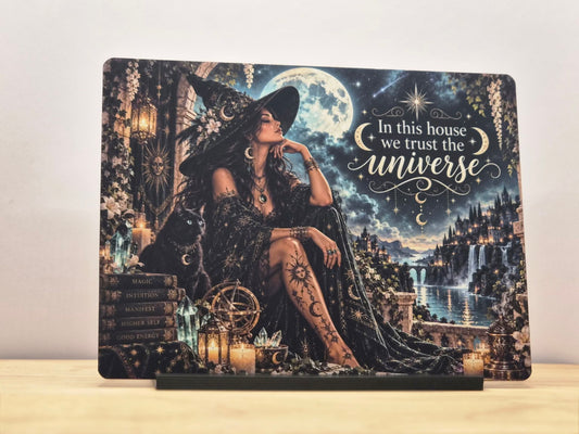 In this house we trust the universe metal sign with a witch, black cat, full moon, crystals and fantasy castle landscape