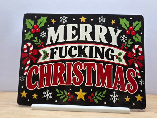 Real photo of Merry Fucking Christmas metal sign with bold festive lettering holly and white stand
