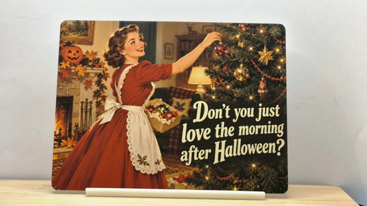 Retro Christmas metal sign reading Don't you just love the morning after Halloween, displayed in its free stand