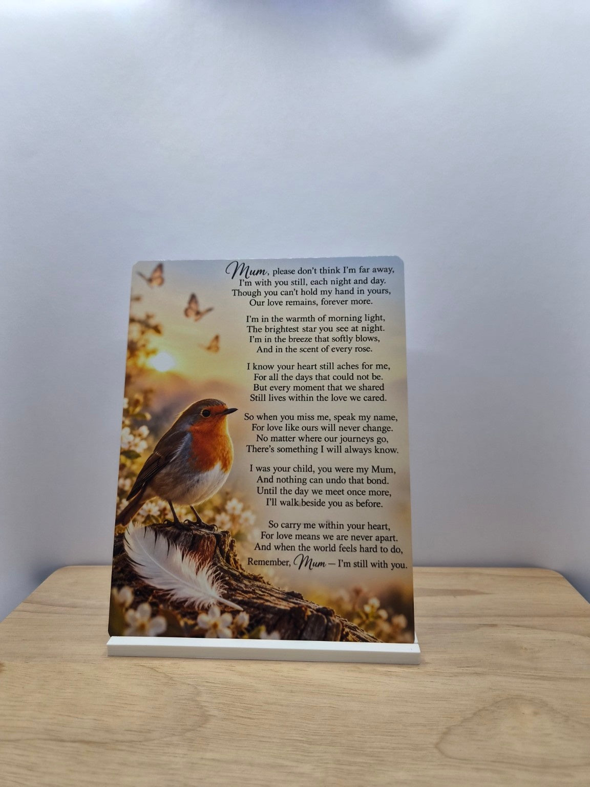 Mum I'm Still With You memorial metal sign with a robin, flowers and a remembrance poem, displayed in a white stand