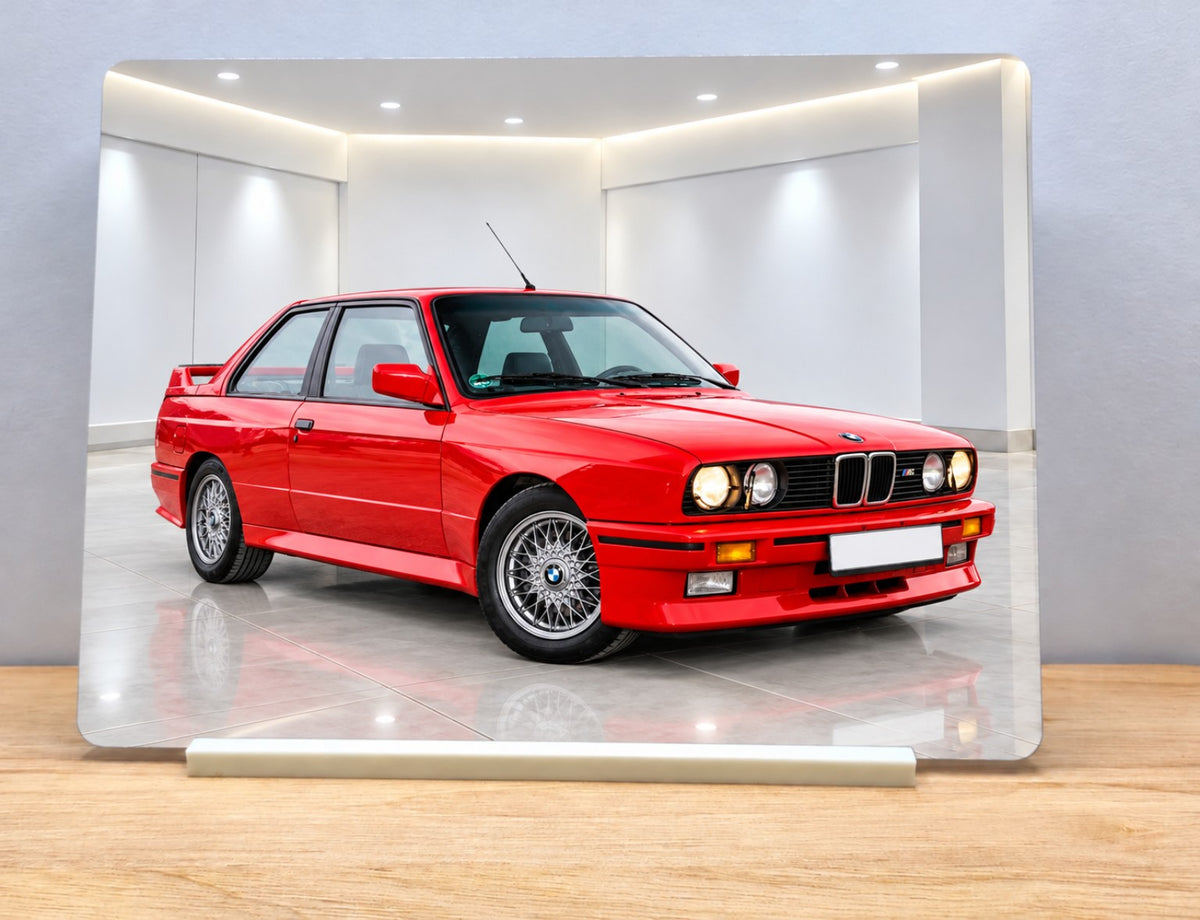 Example personalised car metal sign showing a red BMW in WardCraft's white showroom with the included white stand