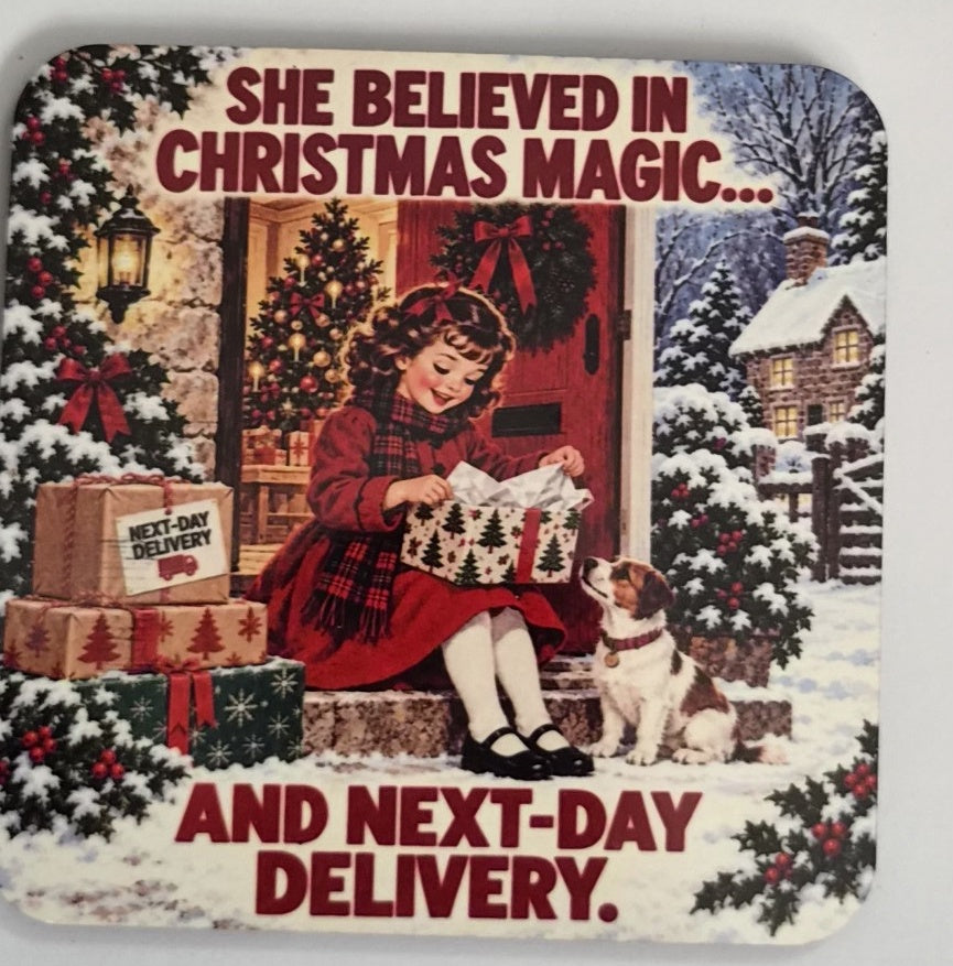 Christmas magic coaster showing a girl opening a gift beside a dog in the snow