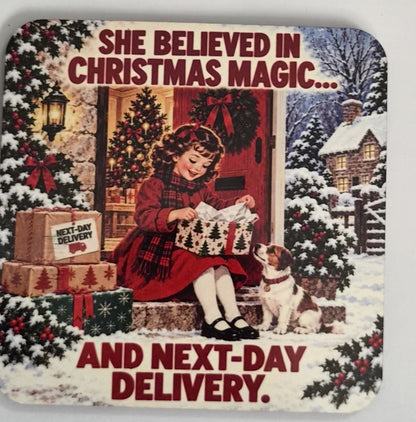 Christmas magic coaster showing a girl opening a gift beside a dog in the snow