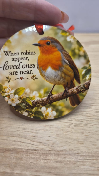 Round robin memorial tree decoration with red ribbon and the words When robins appear, loved ones are near