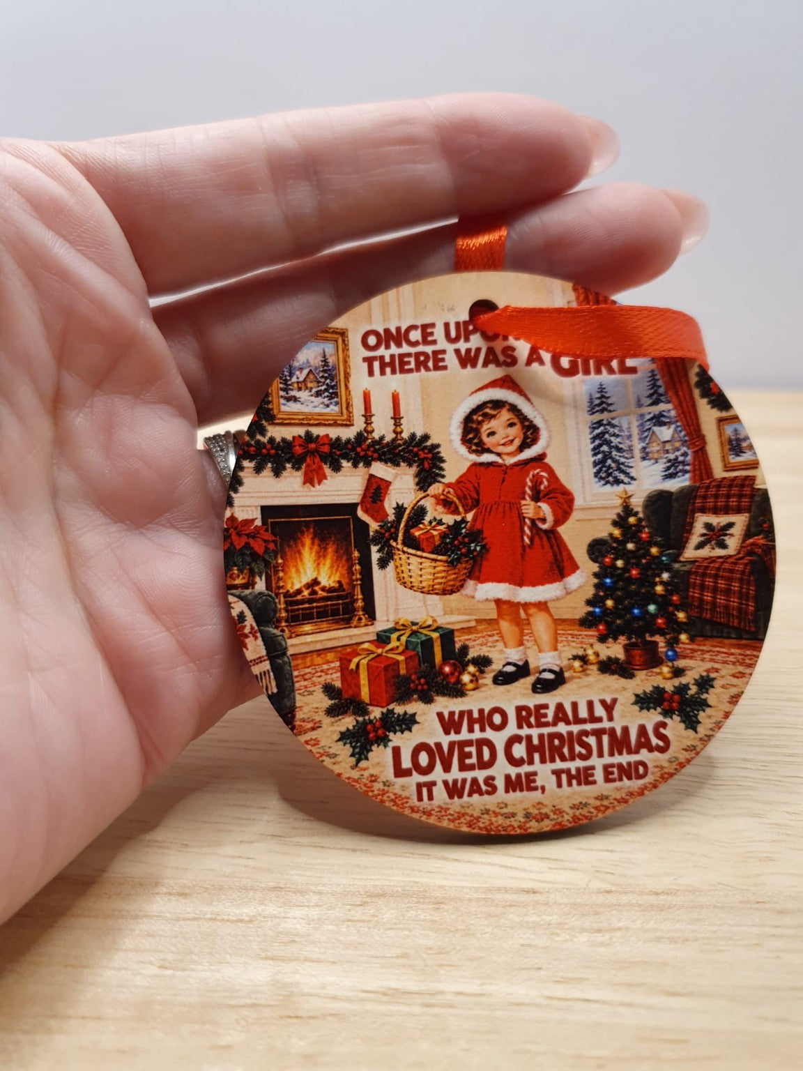 Round Christmas tree decoration with vintage festive artwork and red hanging ribbon, WardCraft design example