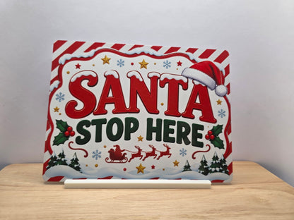 Santa Stop Here red and white Christmas metal sign displayed with its white stand